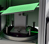 Tilted calibration plane illuminated by a stripe pattern of green light.