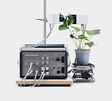 emitter and detector heads clamped on a strawberry plant leaf mounted on adjustable lab jack, showing front panel with detector, LED array, trigger and system connectors